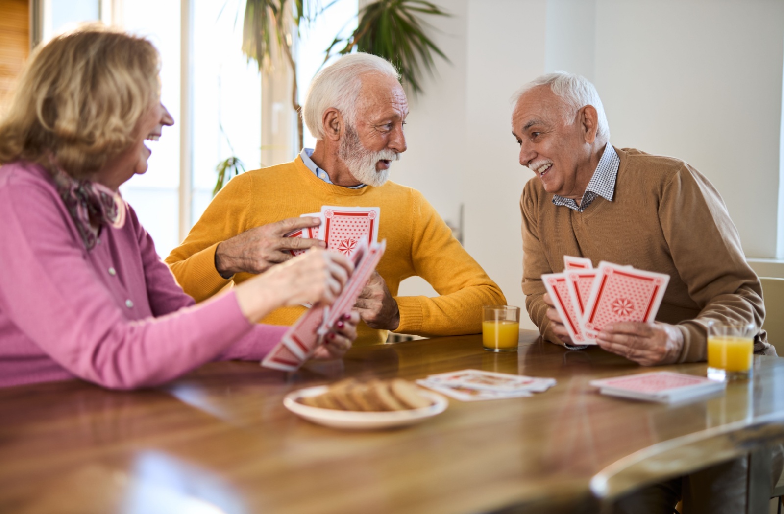 Seniors play cards in an assisted living community.