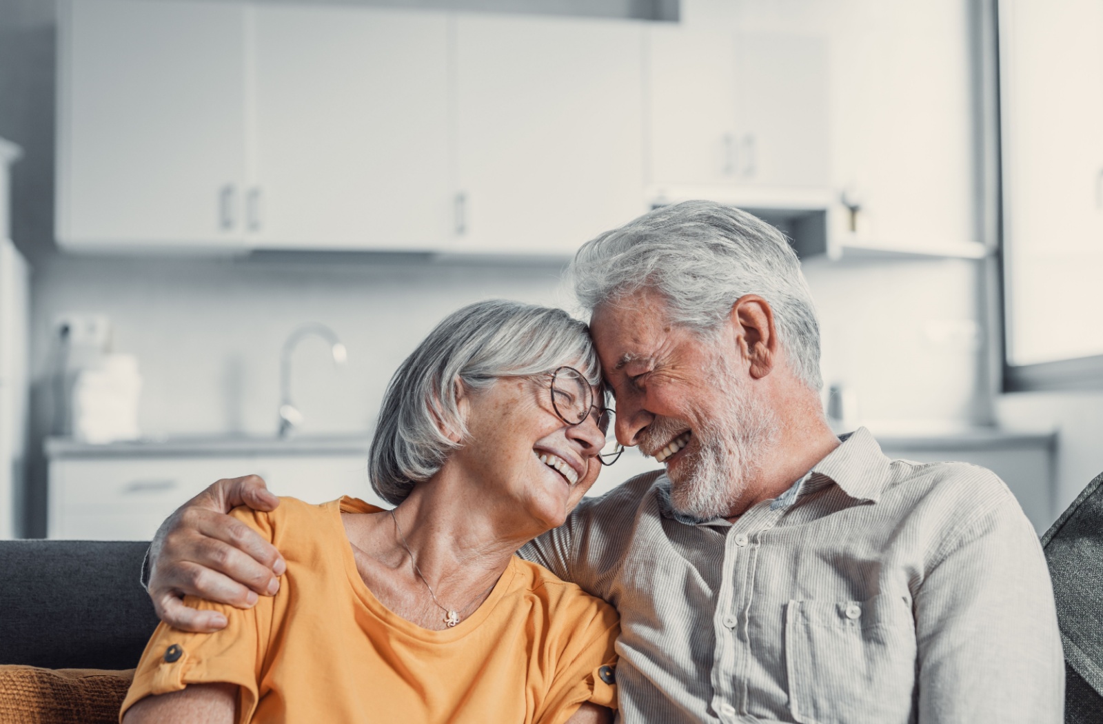 A mature couple happily embrace each other in their assisted living community.