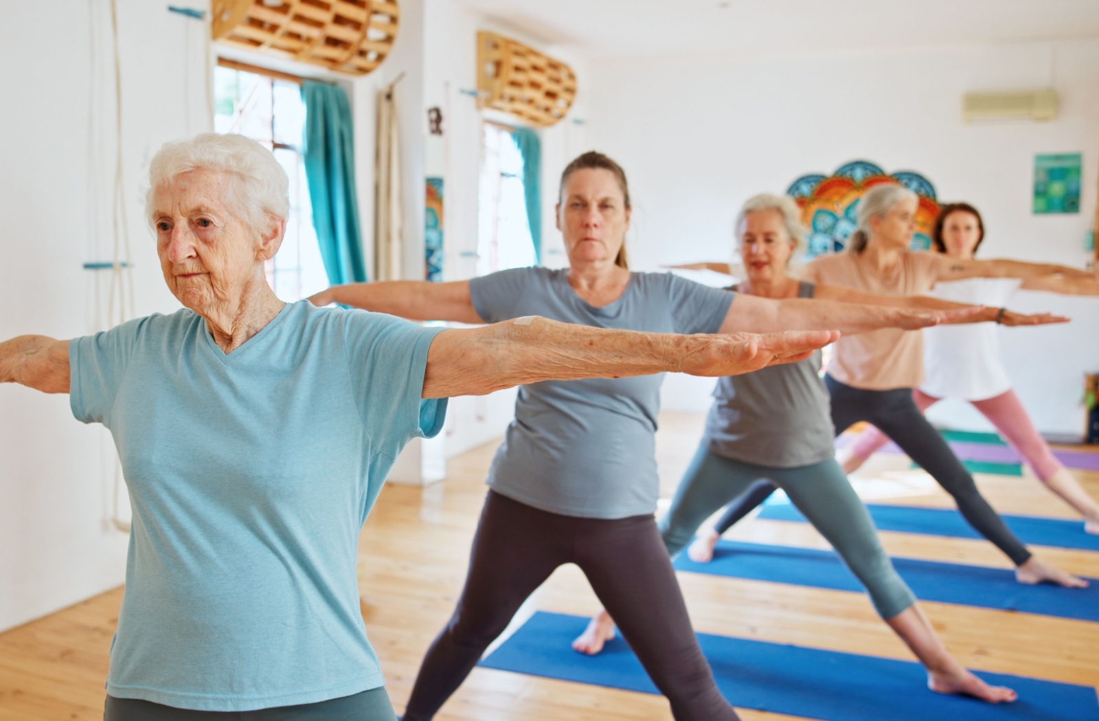 Yoga class for seniors in assisted living focusing on balance and wellness in a bright studio setting